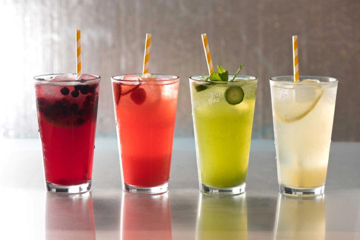 Colorful-drinks in four glasses with straws
