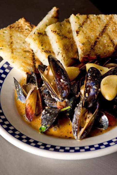Mussels with toast and butter in broth