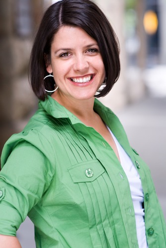 Shows a professional headshot of a business coach, woman, casual, half body, outside