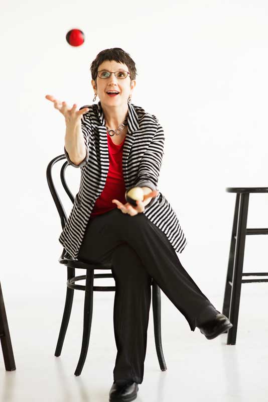 Professional business portrait of a woman business coach juggling